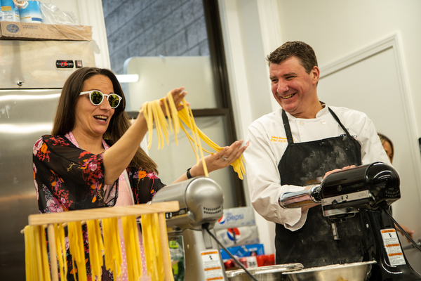 group holding long pasta