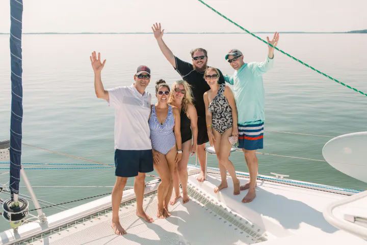 happy friends on sailboat