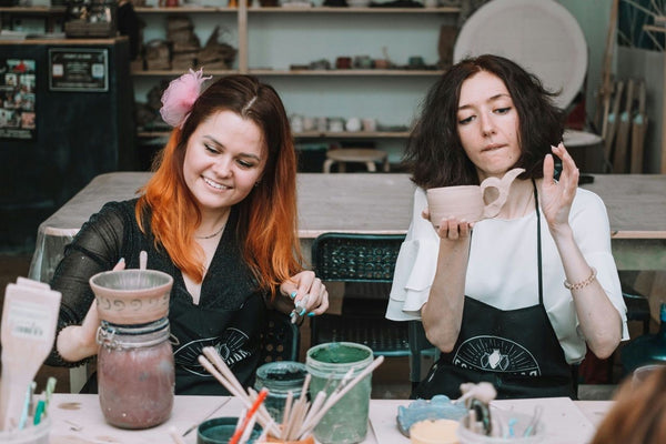 happy women with pottery