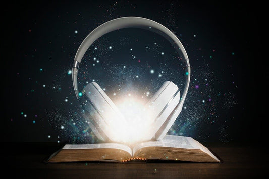 headphones on a book with light and stars behind