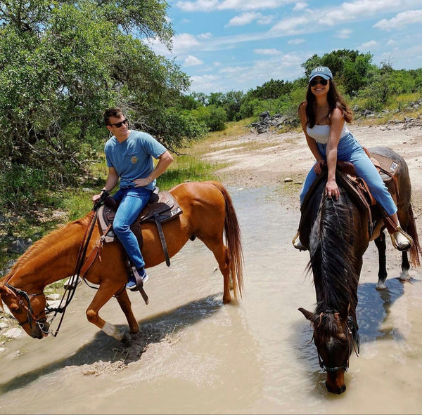 horseback riding couple outside