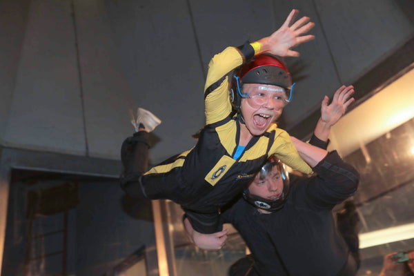 kid with help indoor sky diving