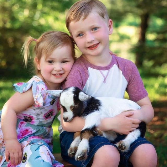 kids holding goat.jpeg