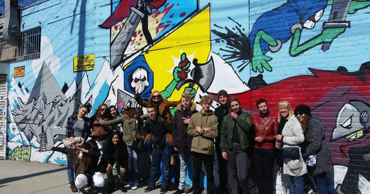 large group with graffiti wall.jpg