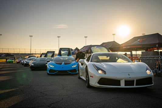 lineup of sports cars at sunset
