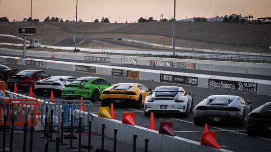 3 luxury cars driving on a racetrack