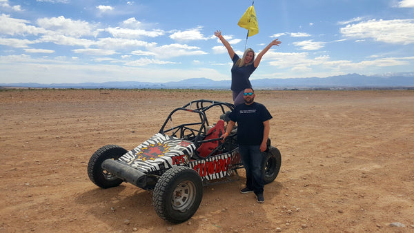man and woman with dune buggy