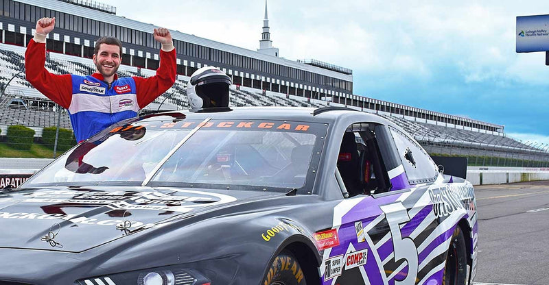 man-cheering-purple-car
