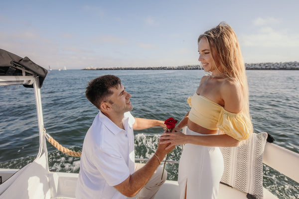 man-giving-woman-rose-on-boat