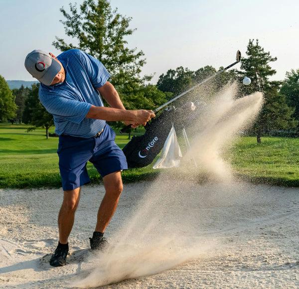 man-hitting-golf-ball-in-sand