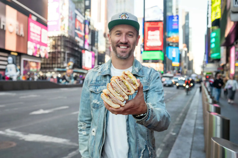 man holding sandwiches