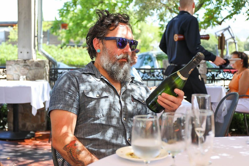 man-looking-at-bottle-of-wine
