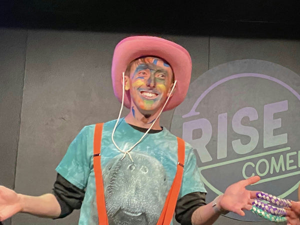 Man on stage in pink hat