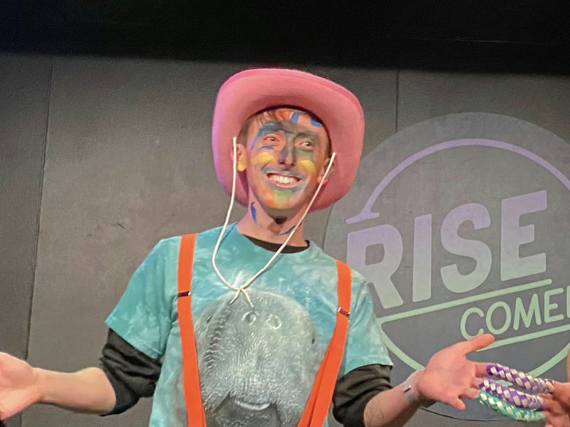 Man on stage in pink hat