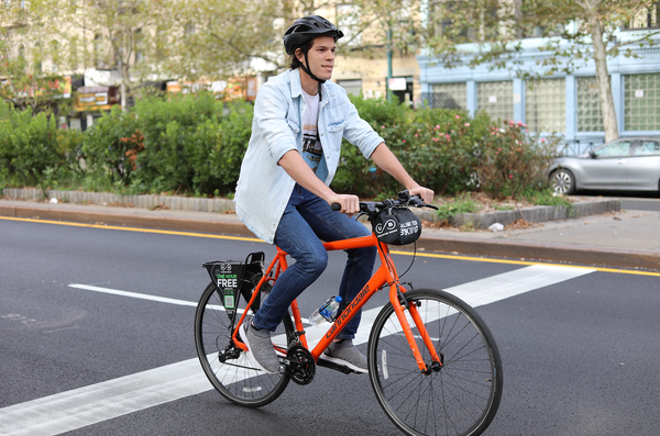 man riding red bike