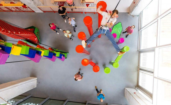 man safely dropping from a climbing wall