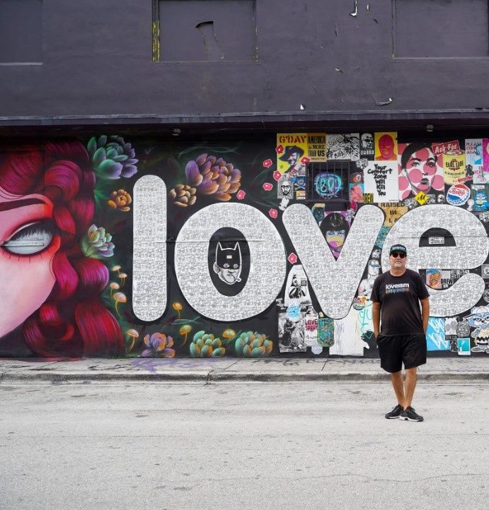 man-standing-in-front-of-street-art