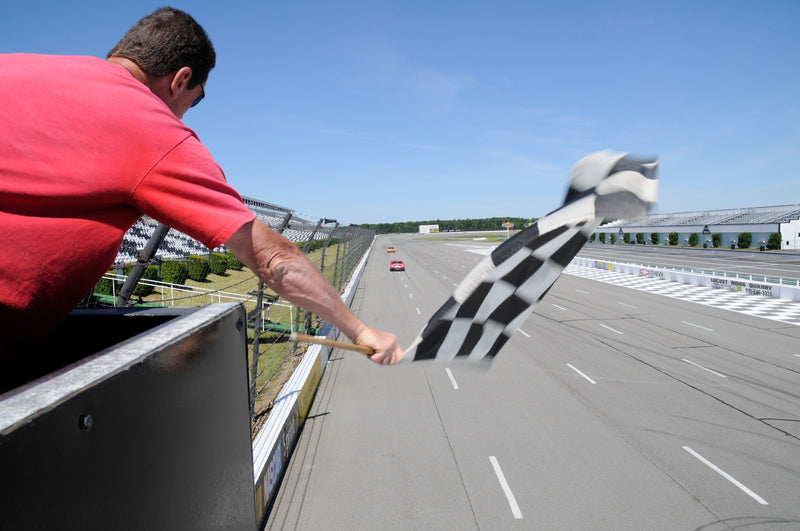 man-waving-flag-racetrack