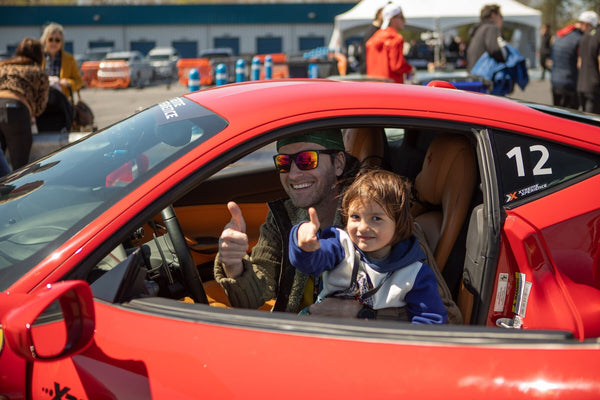 man and son giving thumbs up in a car