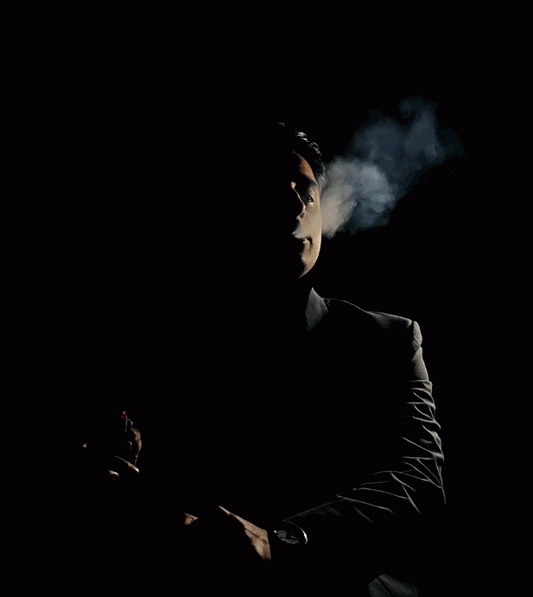 man smoking in the dark