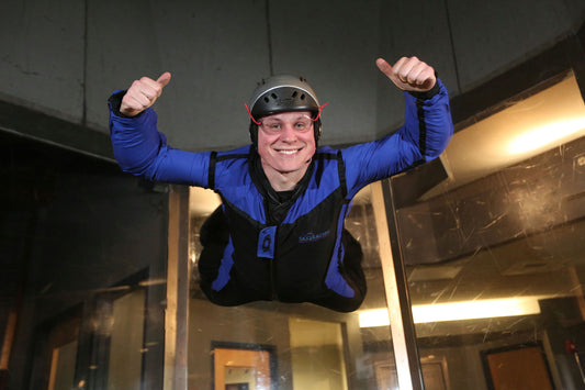 man with thumbs up indoor sky diving
