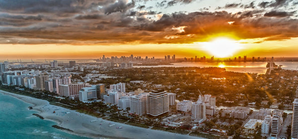 helicopter over beach at sunset