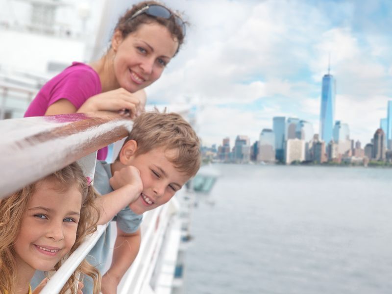 mother-and-children-looking-over-water-with-new-york-background