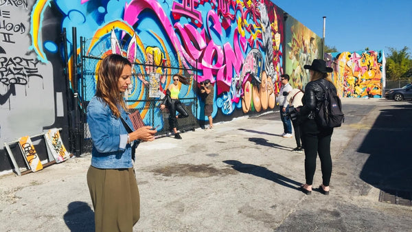 group in front of a mural