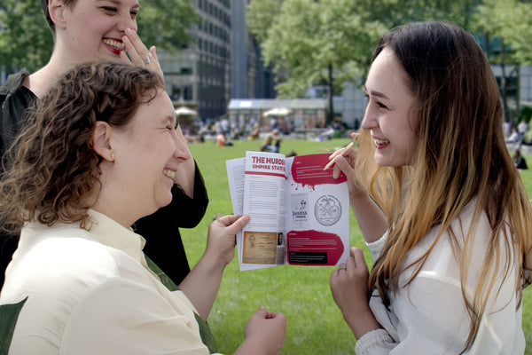 nyc hand holding booklet