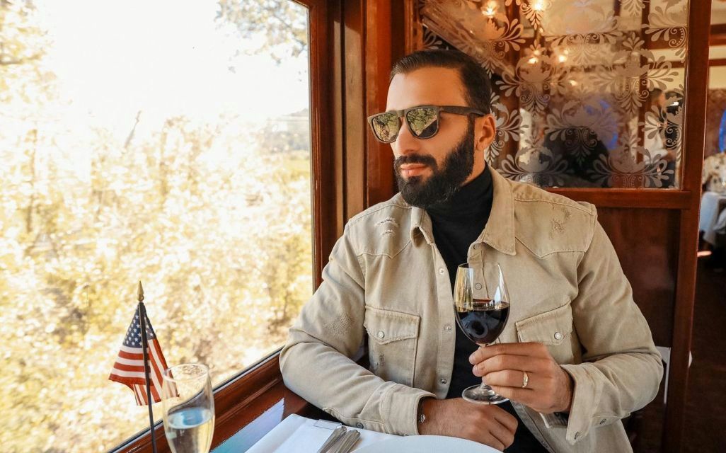 next-to-train-window-drinking-wine