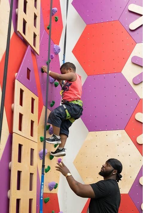 parent helping child climb