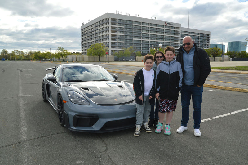 parents and kids with sports car