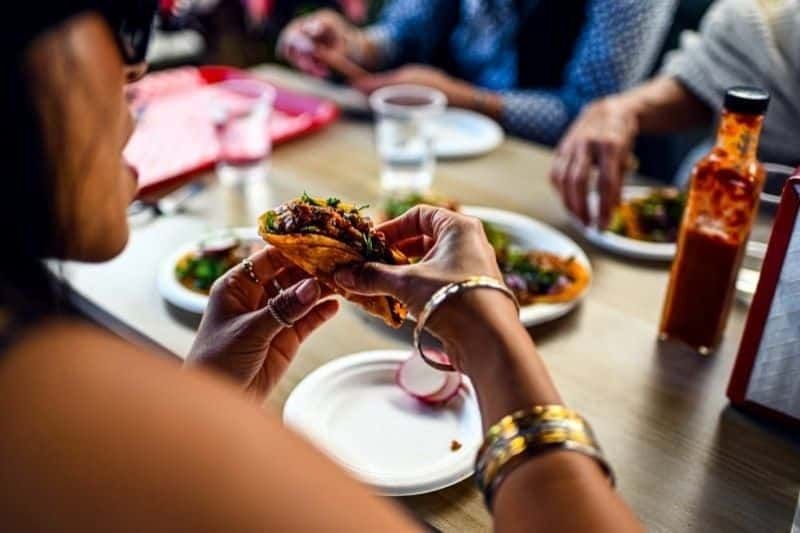 person eating taco