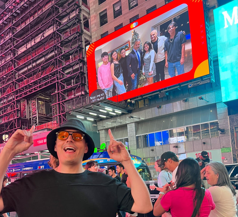 person-posing-under-billboard-with-family-photo