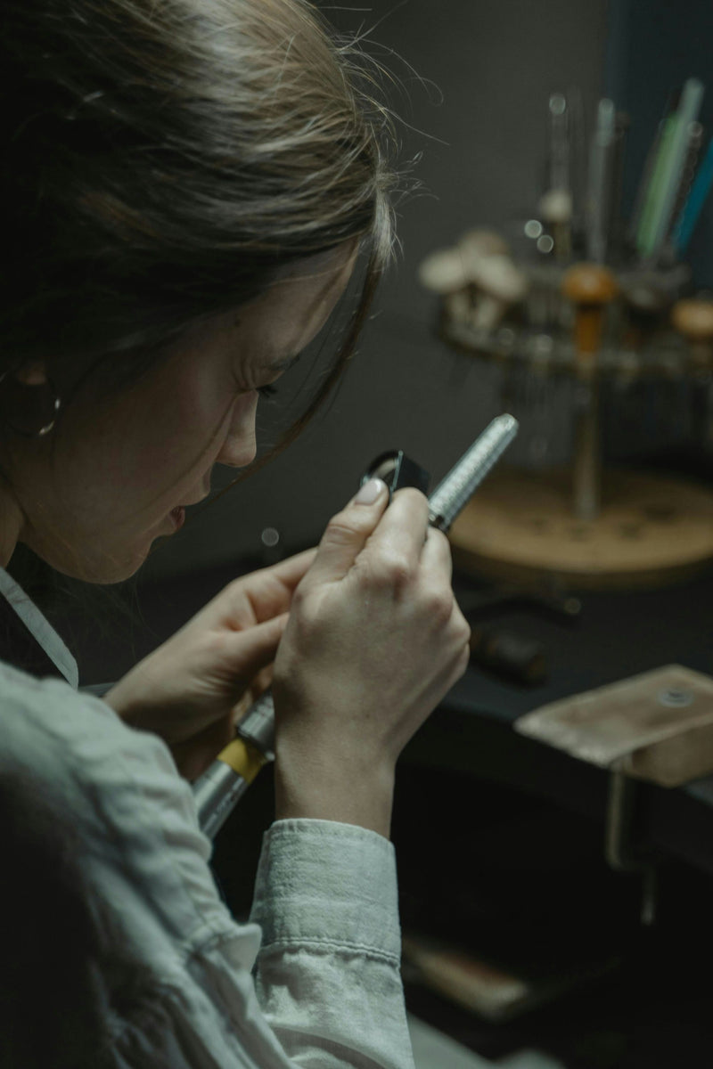 person working on spoon ring