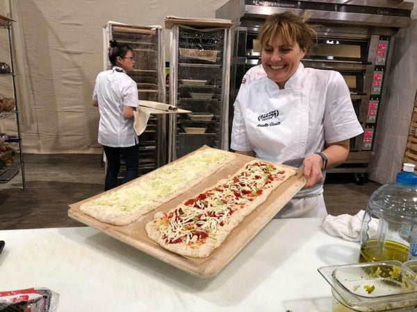 Groups grabbing pizza from tray