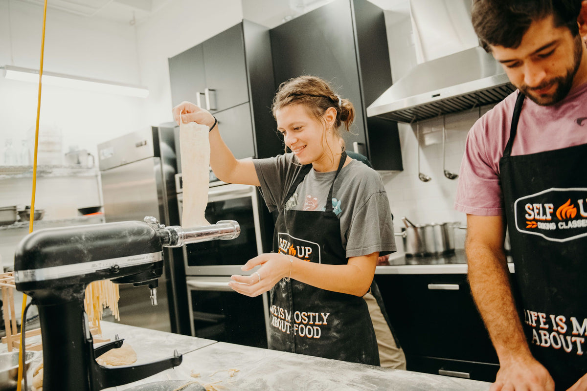putting-dough-through-pasta-maker