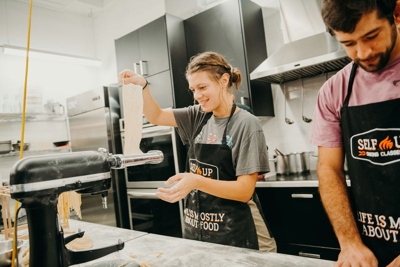 putting-dough-through-pasta-maker