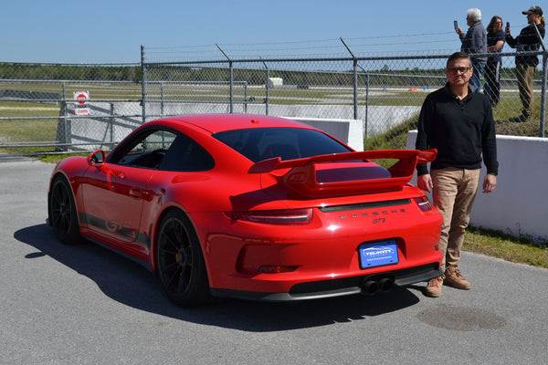 red sports car and man