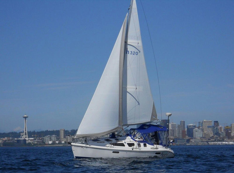 sailboat-cruising-with-skyline-in-background