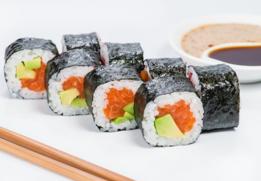 rolling sushi up close with salmon and tuna