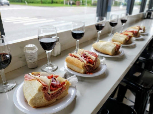 sandwiches with glasses of wine