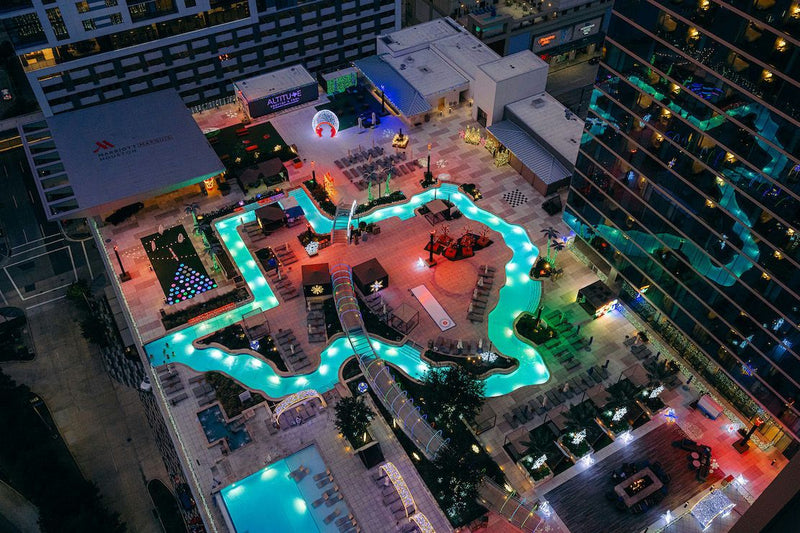 spa-day-pass-and-pool-pass-marriott-marquis-houston-texas-shaped-rooftop-pool-night-aerial-signature-feature.jpg