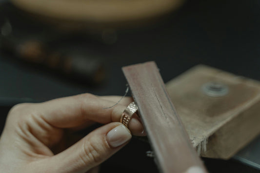 person working on spoon ring
