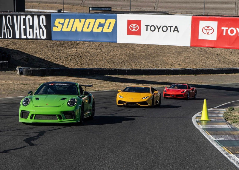Supercars and signs at track