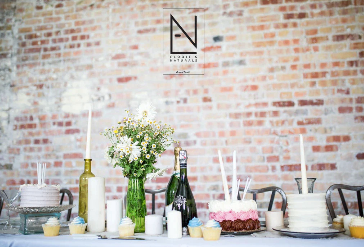 table full of cakes and flowers