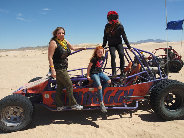 two men and one woman with a dune buggy