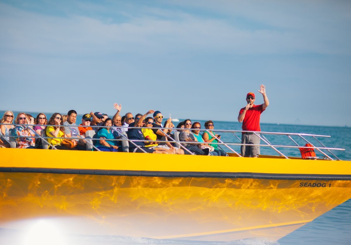 tour-guide-waving-from-speedboat