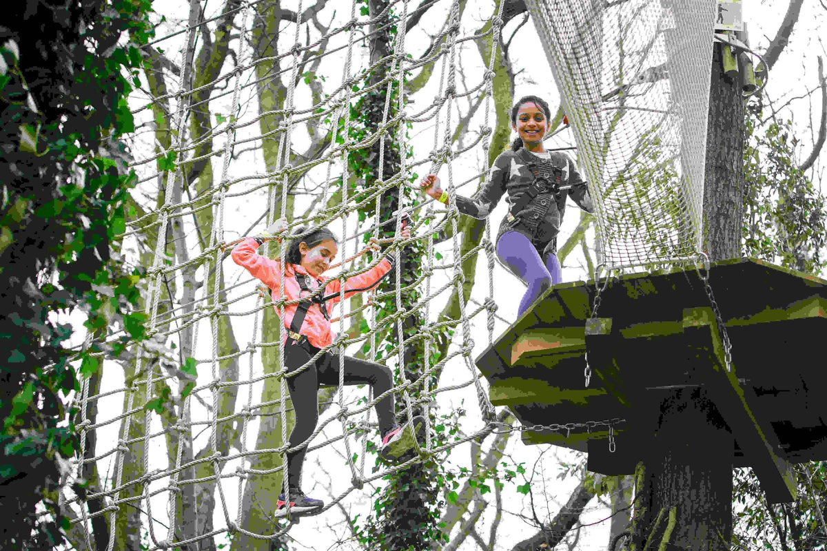 two-girls-going-through-a-rope-ladder-bridge