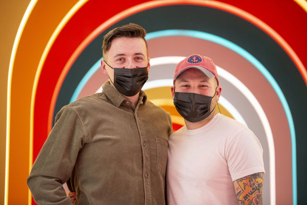 two-guys-with-colorful-wall